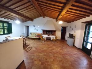 a large living room with a table and chairs at Podere Santa Giulia - casale Francianina in Piombino