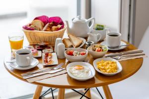 a breakfast table with eggs and bread and coffee at La Bellezza Eco Boutique Hotel in Kamari