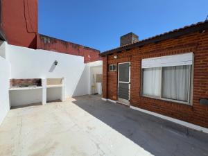 an empty parking lot next to a brick building at La Morenita in Colón
