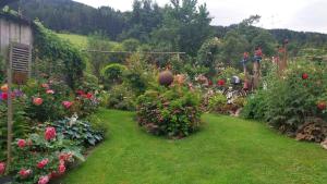 a garden with many different flowers and plants at Thalerhof in Roppen
