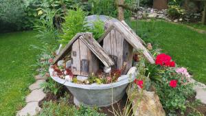 a bird bath with a bird house in a garden at Thalerhof in Roppen