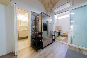 a glass refrigerator in a room with a window at Holiday Home San Lazzaro in Lecce