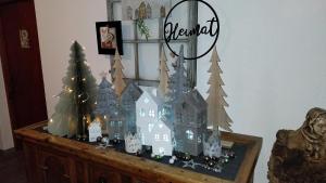 a model of a house on a table with christmas trees at Thalerhof in Roppen