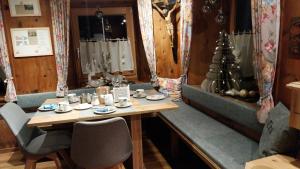 a dining room with a table and a christmas tree at Thalerhof in Roppen