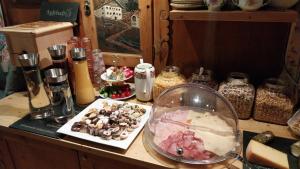 a counter top with a bowl of food and other items at Thalerhof in Roppen
