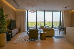 a living room with a couch and a table at Al Malfa Resort & Hotel in Unayzah