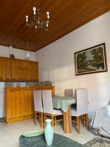 a kitchen with a table and chairs and a chandelier at Agora Mansion in Arachova