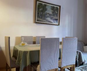a dining room table with chairs and a picture on the wall at Agora Mansion in Arachova
