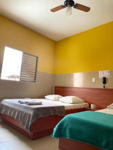 a bedroom with two beds and a ceiling fan at Hotel Gasometro in Sao Paulo +14 photos