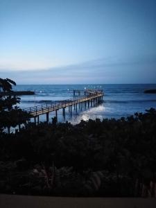 a pier in the ocean with the ocean at Casa Skyros in Arboletes