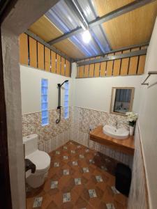 a bathroom with a toilet and a sink at Baan Suan Kayoo 1 Long beach Aow Yai in Ko Phayam