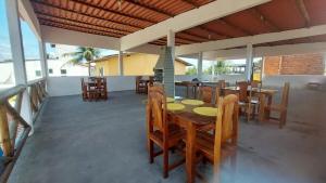 a dining room with wooden tables and chairs at Cantinho do sossego in Ilhéus