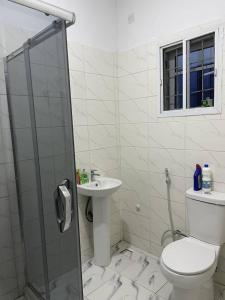 a bathroom with a toilet and a sink at Plot9 Road9 NTA road in Port Harcourt