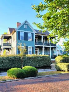 a blue house with a bush in front of it at Kelley House in Pensacola