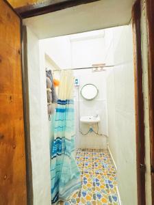 a small bathroom with a toilet and a shower at Aloha LuangPrabang Hostel Capsule in Luang Prabang