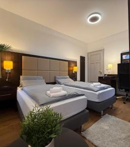 a hotel room with two beds and a television at Linden-Charm Apartments in Hannover +139 photos