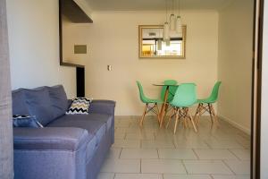 a living room with a couch and a table and chairs at Depto, Condominio Portal del Sol in Arica