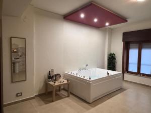 a large bathroom with a large tub in a room at Vespro Guest House in Messina