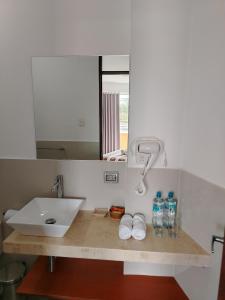 a bathroom counter with a sink and a mirror at Casa Yuraq Hotel Boutique in Chincha Alta +109 photos