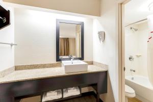 a bathroom with a sink and a toilet at Red Roof Inn PLUS+ Mt Pleasant - Patriots Point in Charleston +20 photos