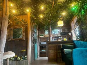 a room with a bar with trees on the ceiling at Les Chambres de Paulette à Theme LA JUNGLE ROOM in Sainte-Marie-la-Mer