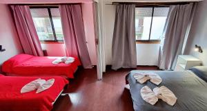 a room with two beds with bows on them at Hotel Cosmos in Mar del Plata