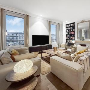 a living room with couches and a flat screen tv at Vue Canal, 3 Suites & Double Salon in Sète