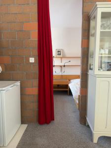 a red curtain in a room next to a brick wall at Haus Wogesa - CharmingStay in Flumserberg +44 photos