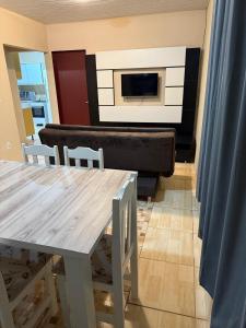 a living room with a table and a fireplace at Ampla Casa Sul da Ilha in Florianópolis