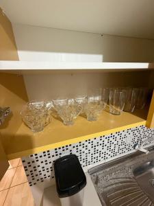 a shelf with glasses on it with a bunch at Ampla Casa Sul da Ilha in Florianópolis