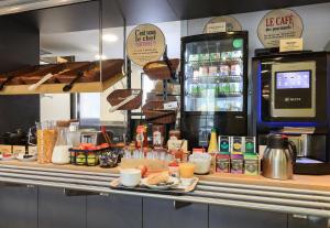 a kitchen with a counter with food on it at B&B HOTEL Chalon-Sur-Saone Sud in Saint-Rémy