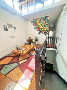 a living room with a table and a mural on the wall at Jonker Vibe Inn in Malacca +16 photos