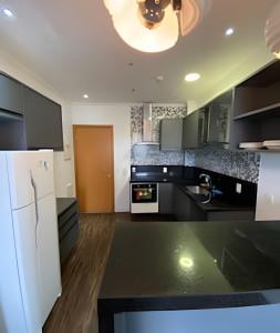 a kitchen with a white refrigerator and a sink at 506 Alphaville Link Studio in Aldeia