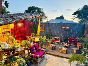 a patio with a bunch of chairs and plants at Swahili Villa in Arusha
