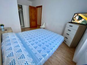 a bedroom with a bed and a dresser and a mirror at Great and cozy Room in the center of Puerto del Rosario in Puerto del Rosario +3 photos