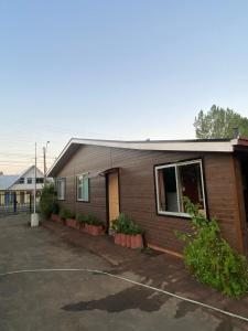 a small house with a parking lot in front of it at Cabaña AL-YEEN in El Manzano +8 photos