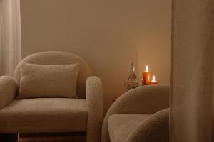 a room with a chair and a candle on a table at Villa MERLINI w sercu Starego Miasta, Grodzka 19 Lublin in Lublin