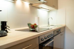 a kitchen with a sink and a bowl of fruit at Ferienwohnungen Citylight Winterberg in Winterberg