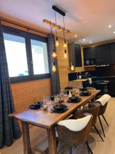 a dining room with a wooden table and chairs at La Foux d 'Allos centre station T4, 7 pers in La Foux +19 photos