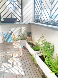a patio with a chair and plants on a balcony at Nid douillet Romainville in Romainville