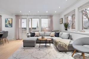 a living room with a couch and a table at Near Downtown - Large Beds - Free Parking in Tromsø +25 photos
