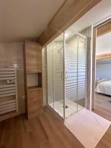 a glass shower in a room with a bed at Location vacances - parking inclus in Puget-sur Argens