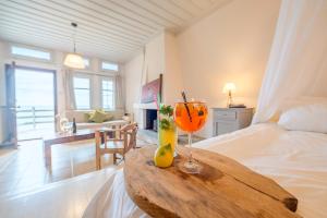 a bedroom with a bed and a table with a drink at Palia Damouhari in Damouchari