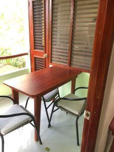 a wooden table and chairs in a room with a window at Hotel Casa Robinson in Las Terrenas +263 photos