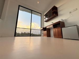 an empty room with a large window and an empty floor at Sky Villa Dikwella in Dickwella