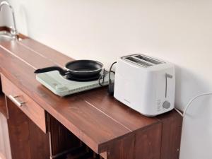 a toaster sitting on top of a wooden counter at Sky Villa Dikwella in Dickwella