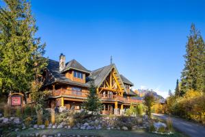 a large log home with a landscaping at Vagabond Lodge at Kicking Horse in Golden