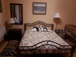 a bedroom with a bed with two pillows on it at Vila Valdonė in Palanga