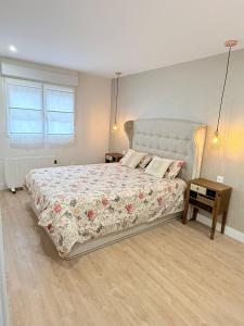 a bedroom with a large bed and a window at Reformado Centro con Terraza in Castro-Urdiales