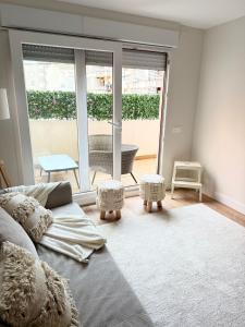 a living room with a couch and a large window at Reformado Centro con Terraza in Castro-Urdiales +20 photos